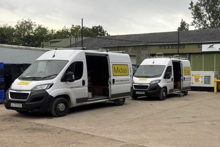 Midas service vans parked at a generator facility, showcasing the company's commitment to generator servicing and maintenance solutions.