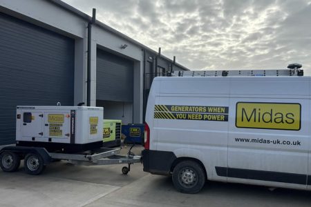 Generator trailer with Midas branding, parked next to a delivery van, showcasing power solutions for generator hire services.