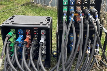 Power distribution equipment with multiple colored connectors and cables, used for generator hire services and electrical distribution solutions.