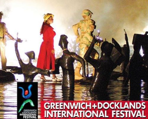 Red-dressed performer among dark sculptures in water, showcasing the Greenwich & Docklands International Festival, with festival logo in the corner.