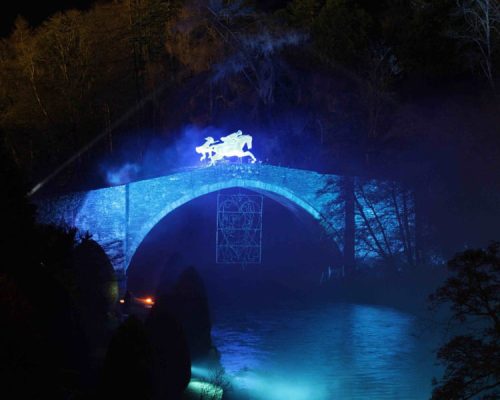 Illuminated bridge featuring a horse silhouette, part of the Iconic Burns event in Alloway, Scotland, showcasing Midas Productions' power solutions for cultural celebrations.