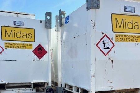 Bunded fuel tanks from Midas Generator Hire, featuring warning labels and company branding, positioned for efficient refuelling solutions.